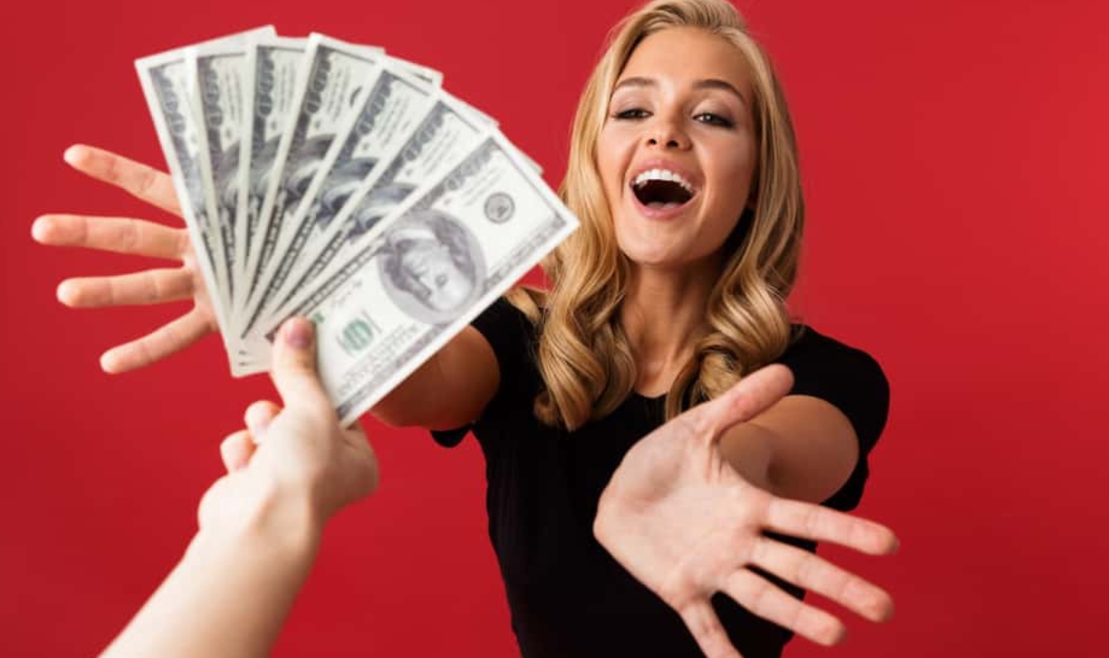 Young Excited Woman Looking At Money, Shutterstock, 1202254711