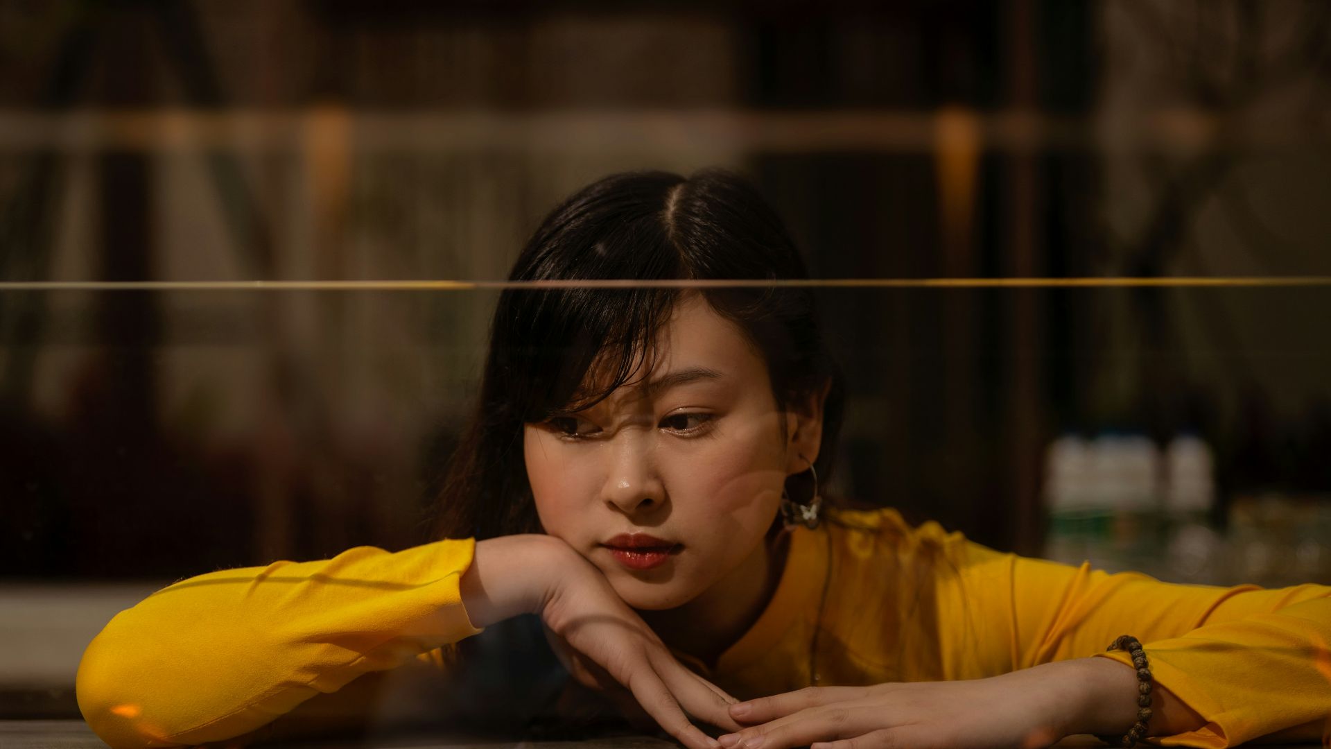 girl in yellow long sleeve shirt holding yellow balloon