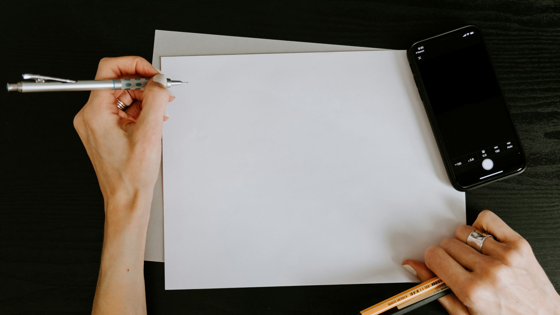 person writing on white paper