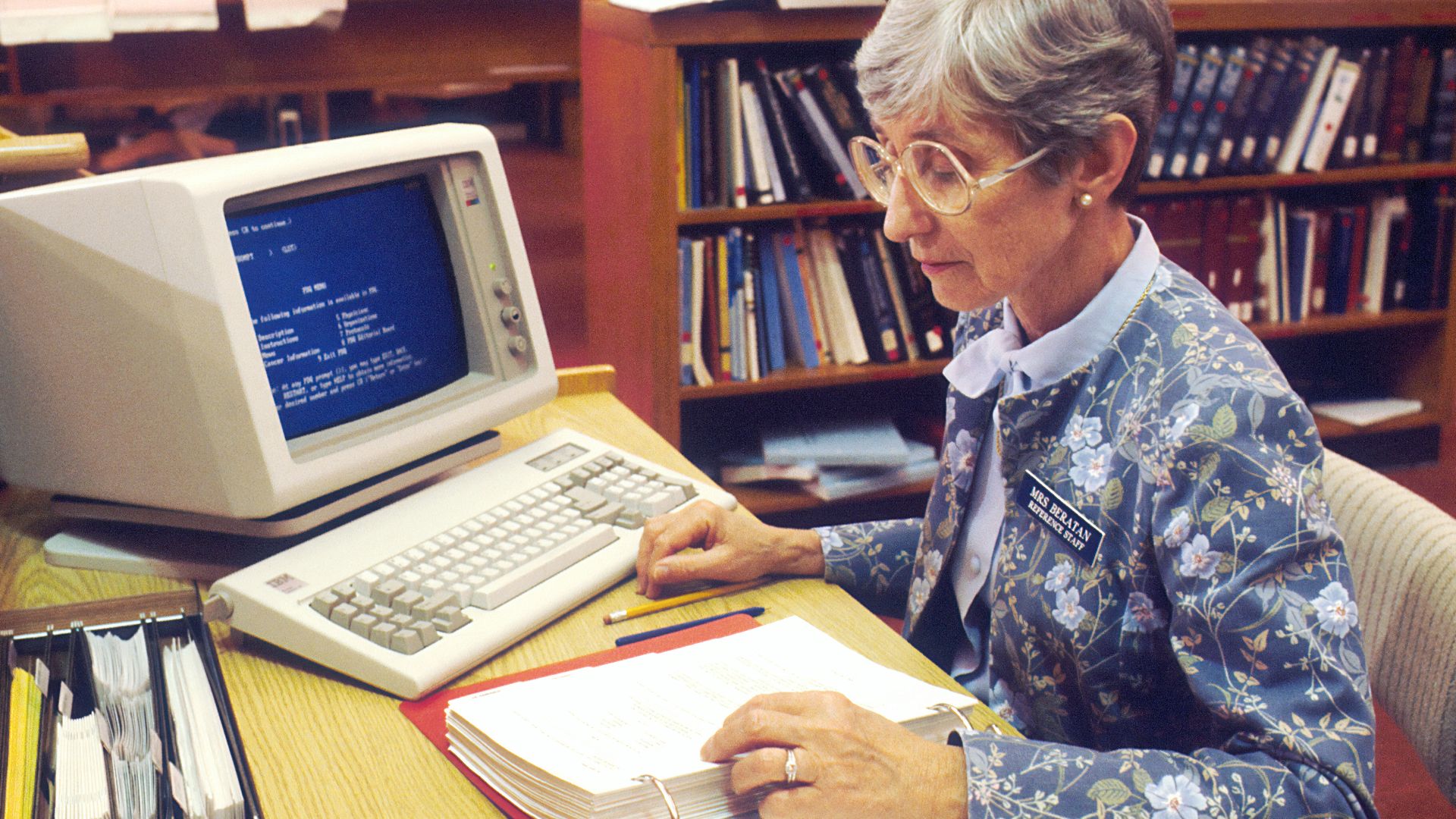woman sitting at desk with desktop computer