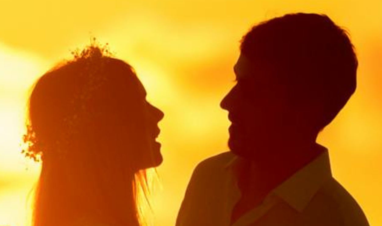 Silhouettes Of Romantic Couple Enjoying Majestic Sunset On Seaside