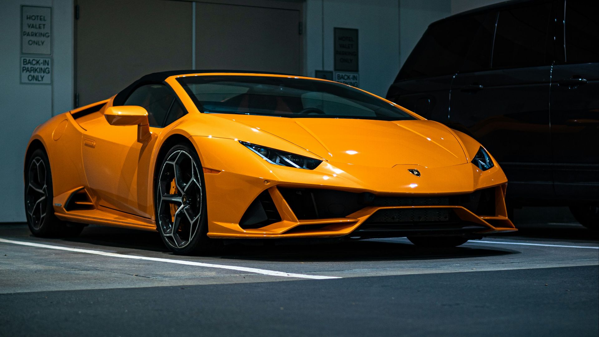 orange lamborghini aventador parked in garage