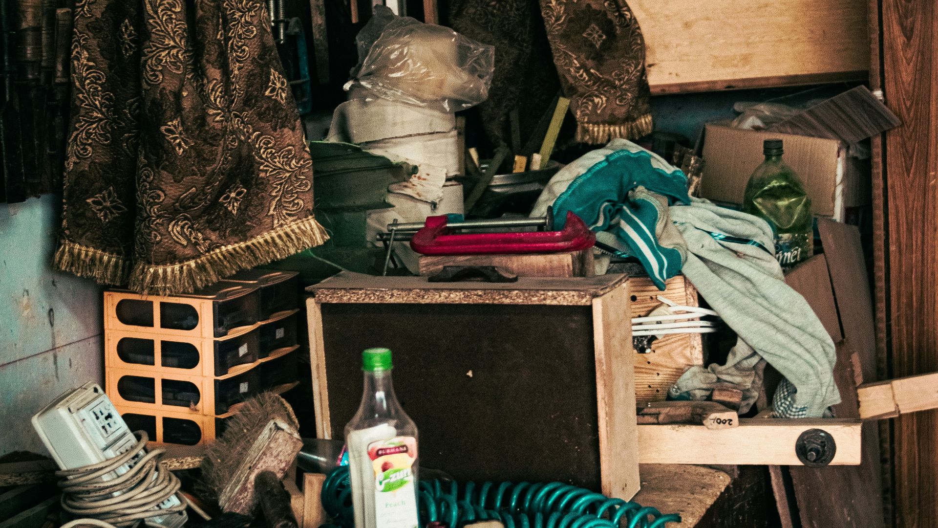 a cluttered room with clothes and other items
