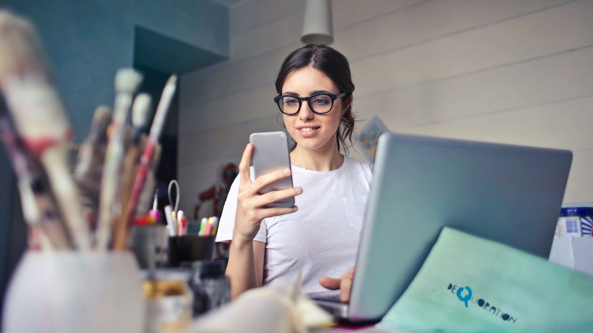 woman in white shirt using smartphone