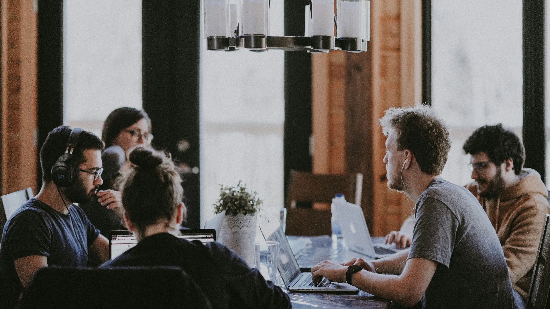 sittin people beside table inside room