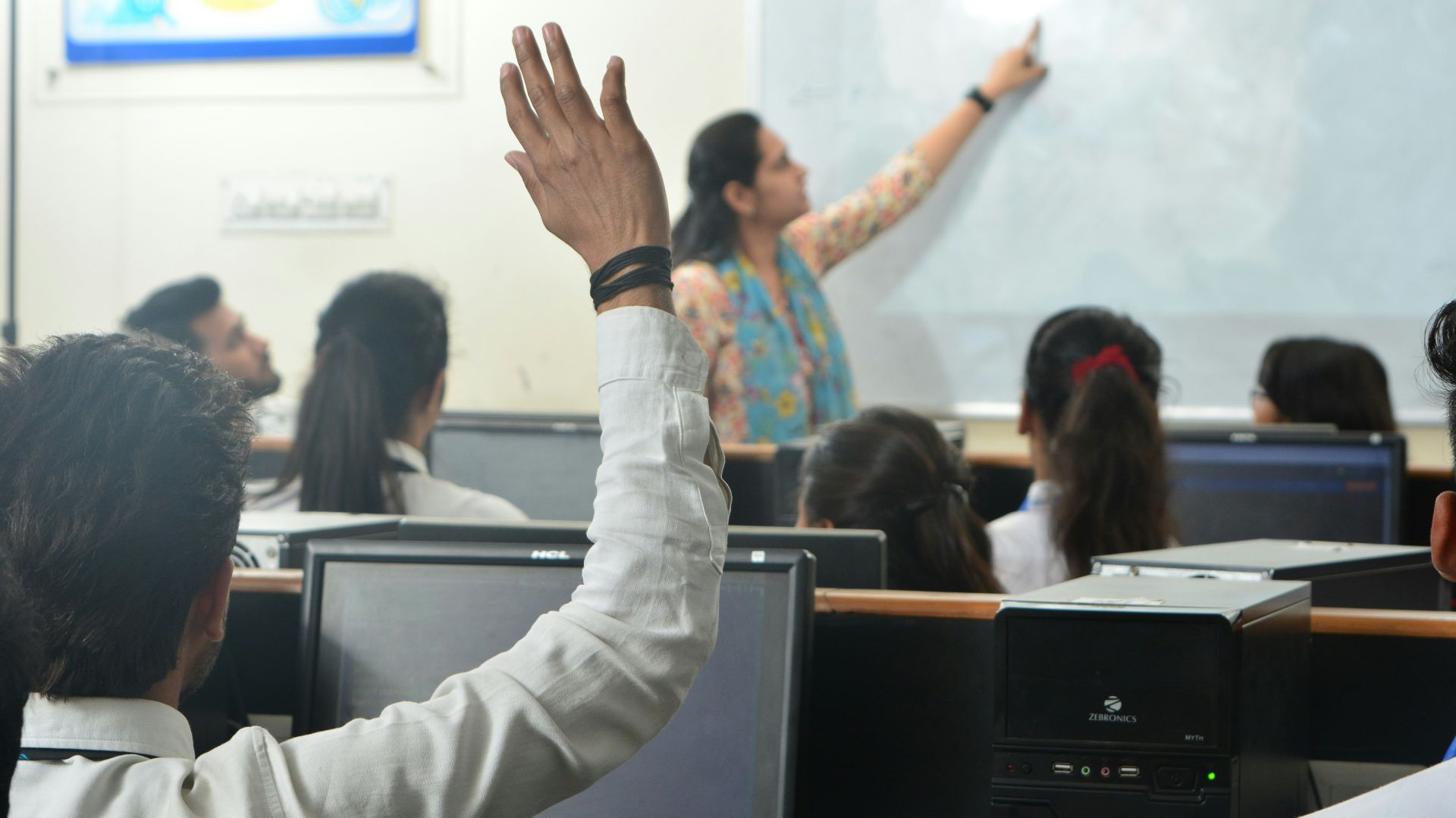 Students and teacher in a computer classroom.