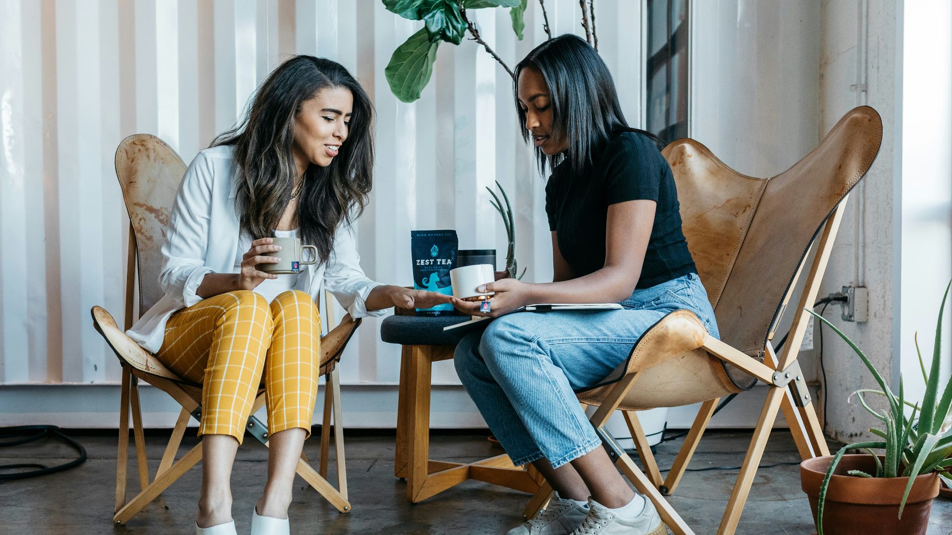 woman in black shirt sitting on brown wooden chair
