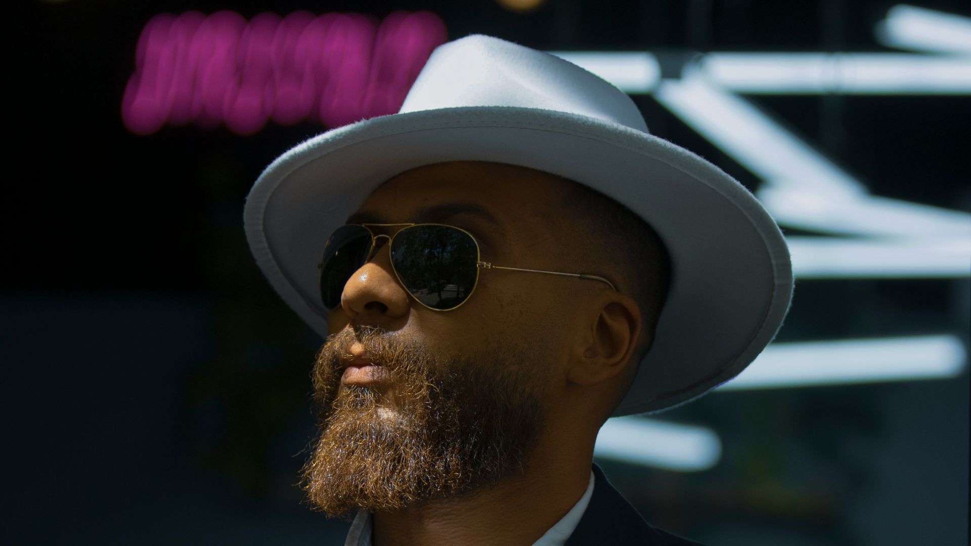 a man wearing a hat and sunglasses