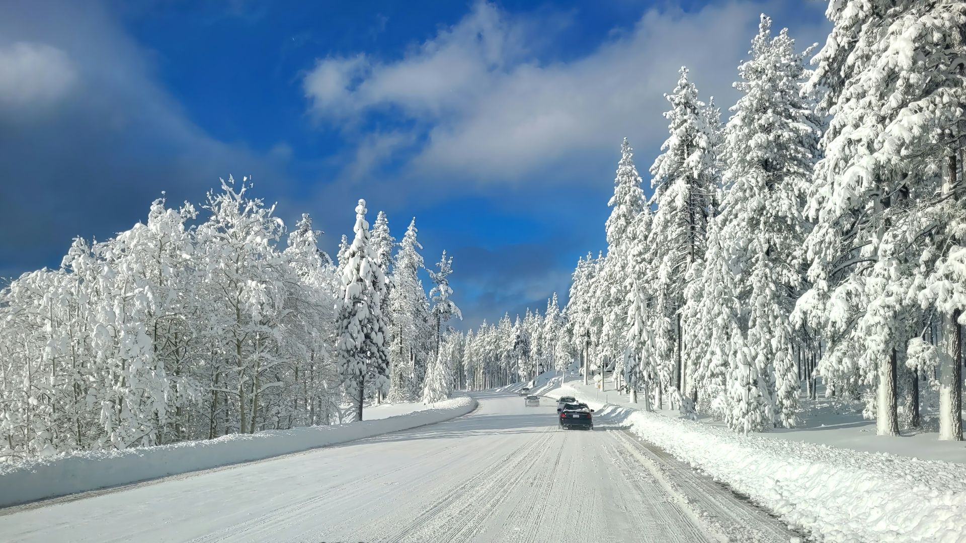 A car driving down a snow covered road