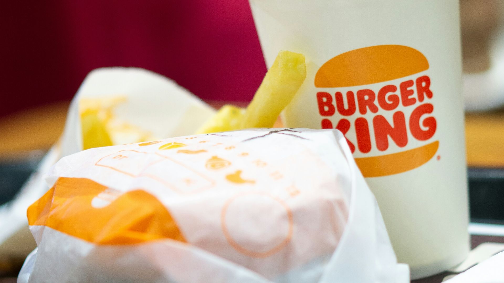 a burger king sandwich and a cup of coffee