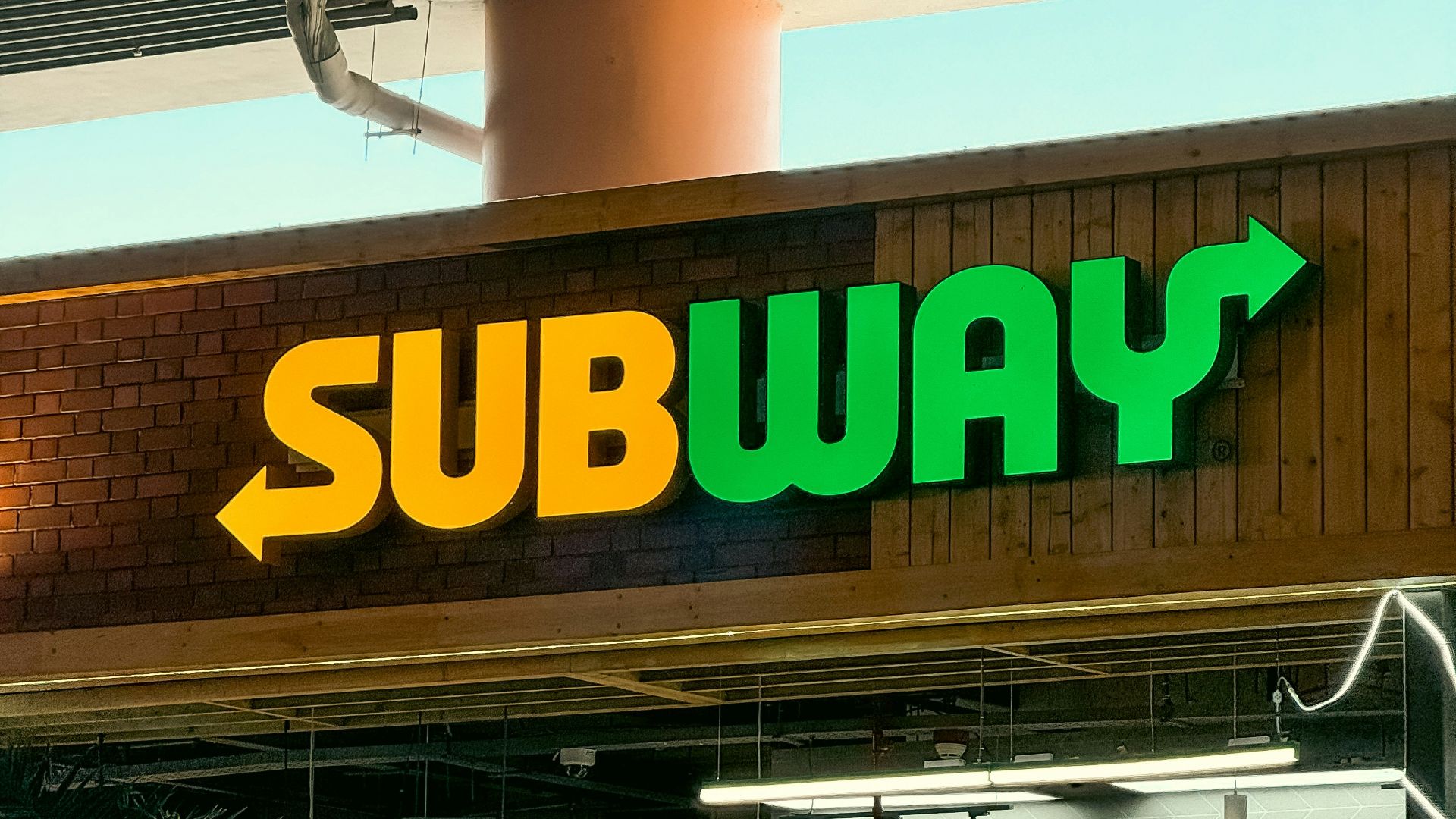 a subway sign above a subway entrance