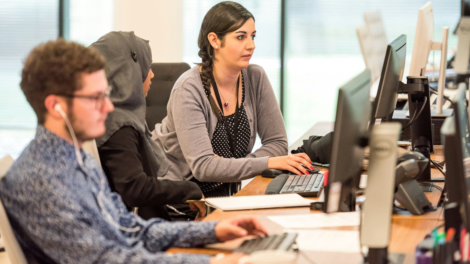 unknown persons using computer indoors