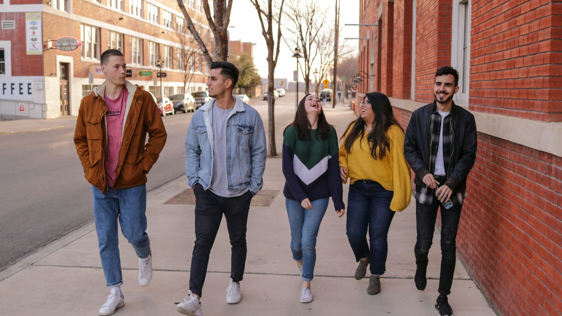 three men and laughing two women walking side by side