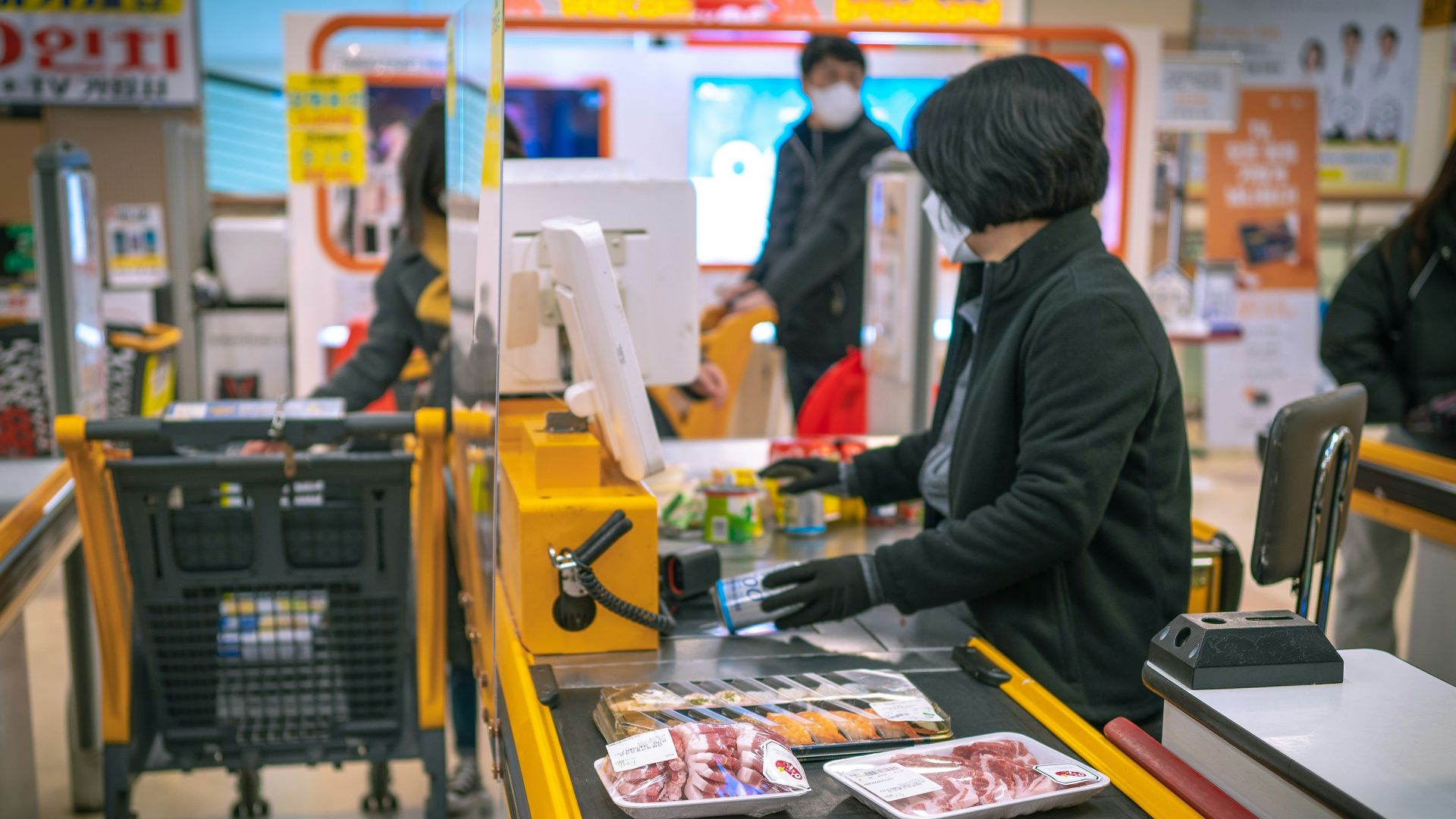 a woman standing at a cash register in a store