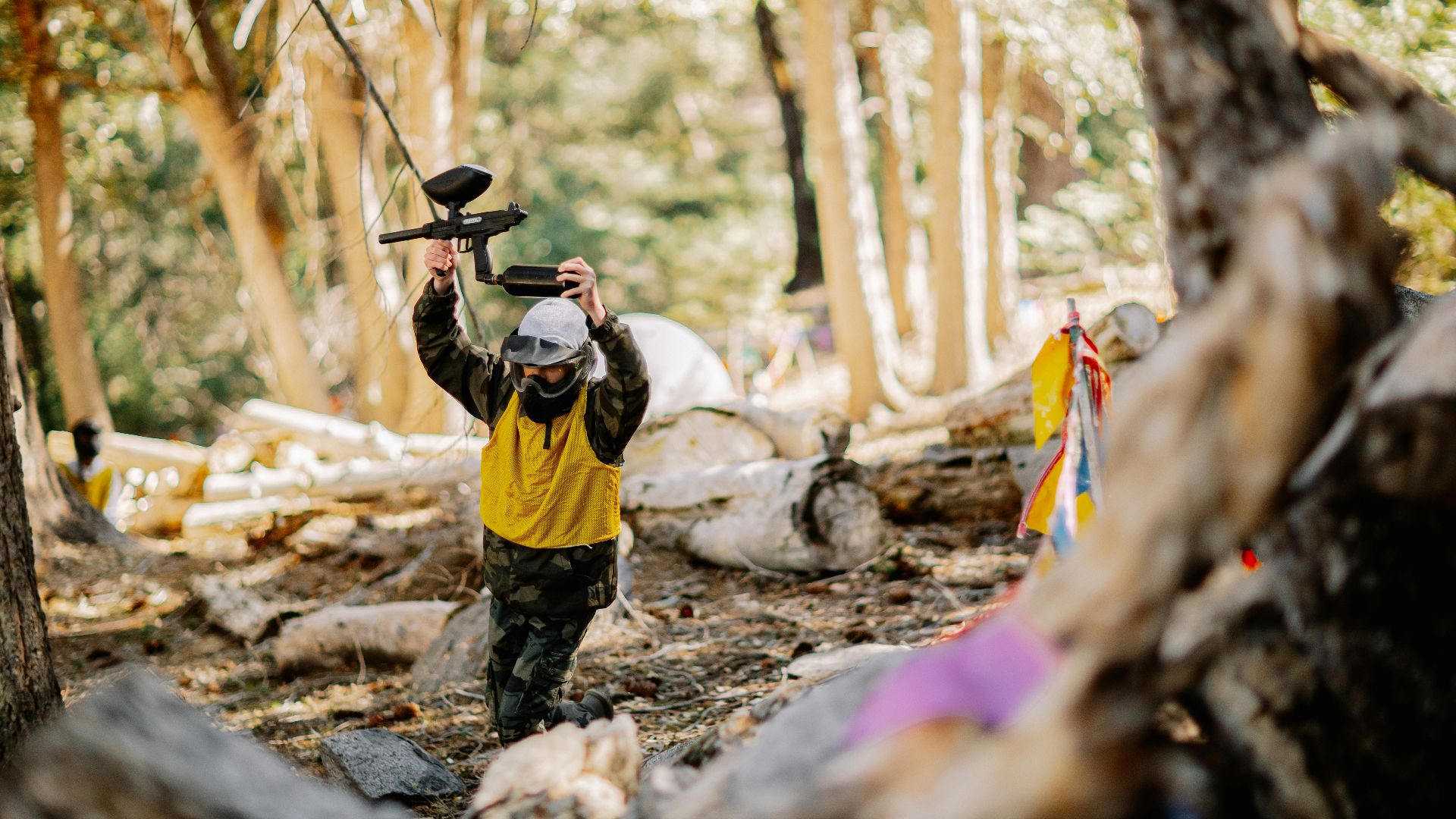 man in yellow shirt and green pants carrying brown acoustic guitar