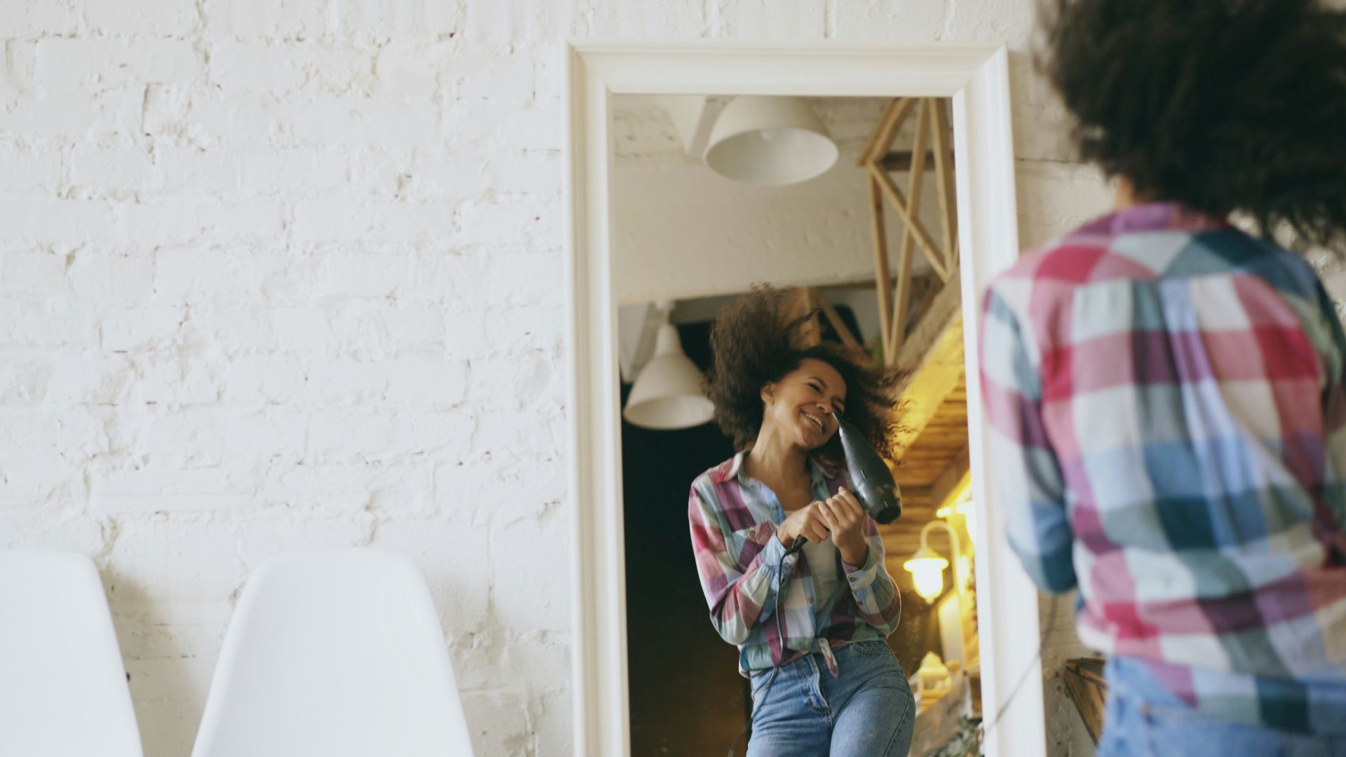 Two women dancing and having fun indoors