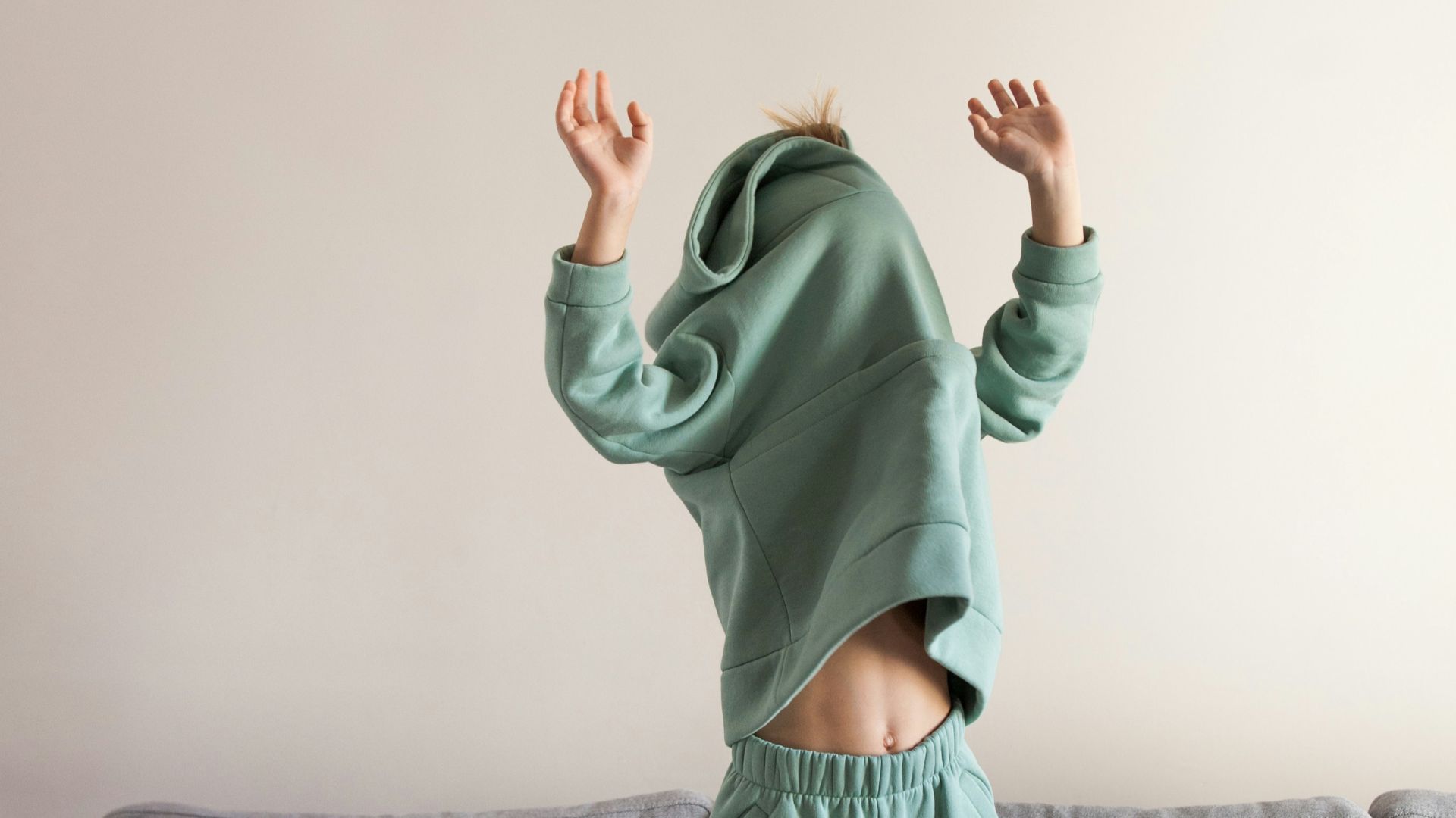 a person jumping on a couch in a living room