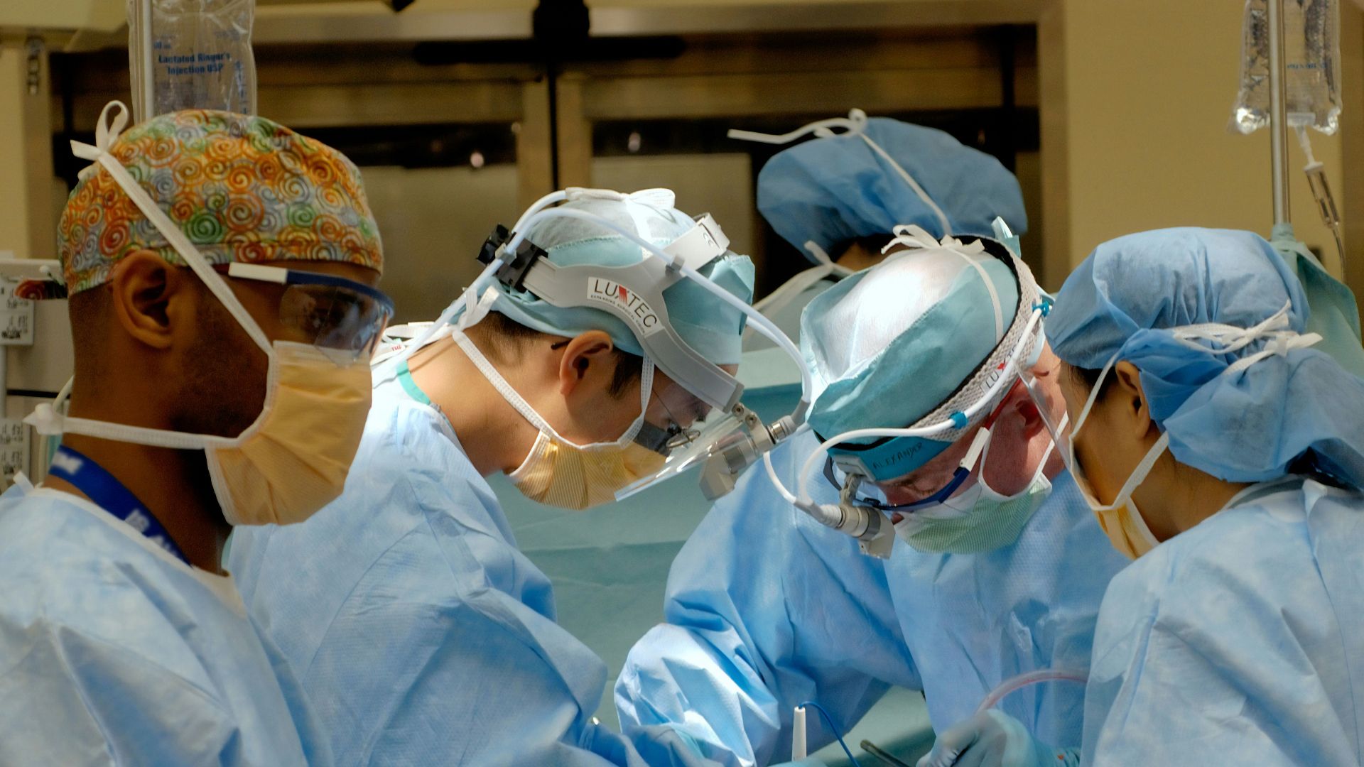 man in white dress shirt wearing white goggles