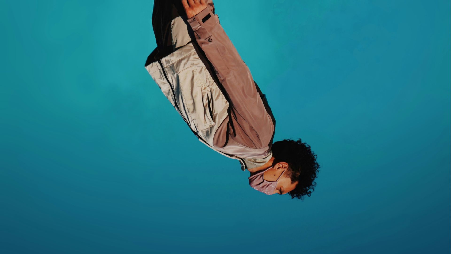 man in brown jacket and black pants