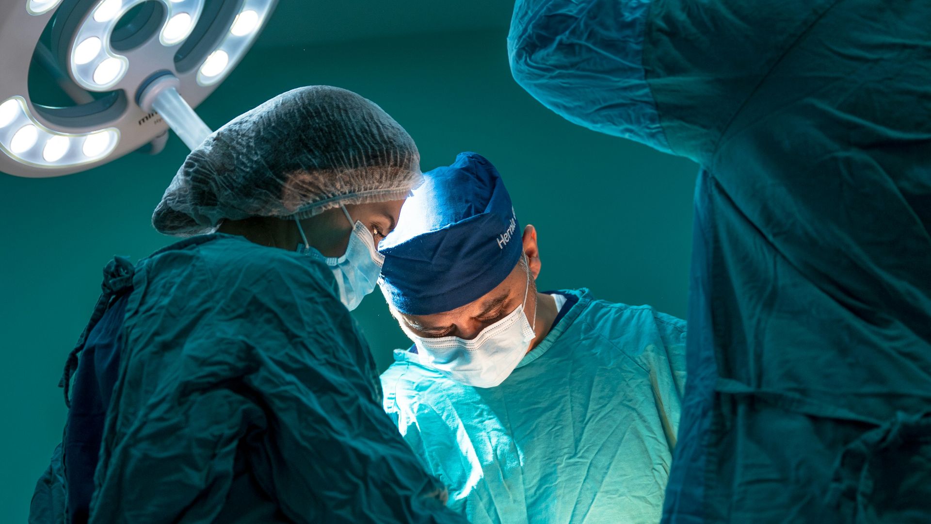 a group of doctors performing surgery on a patient