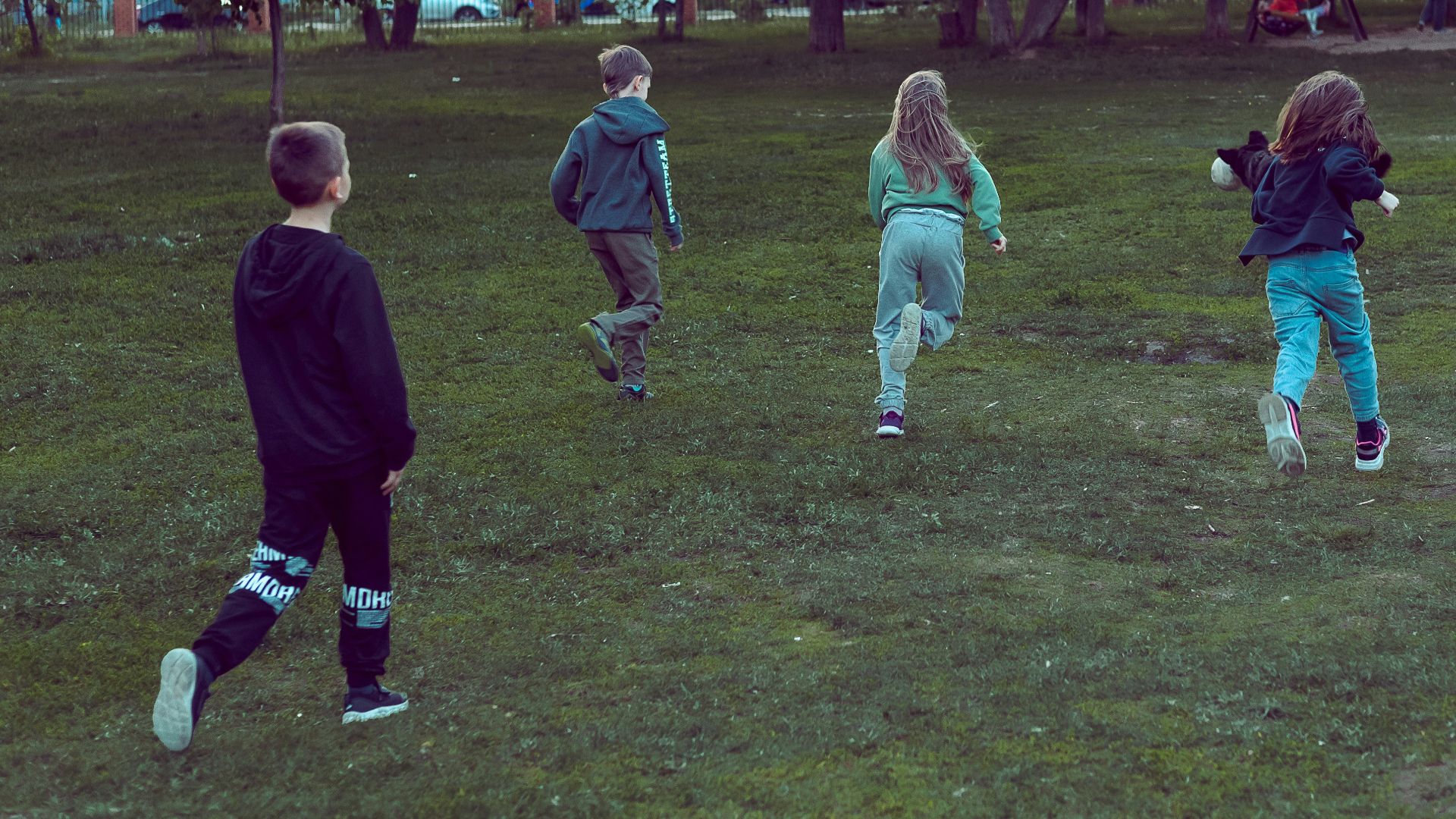 a group of young children playing a game of frisbee