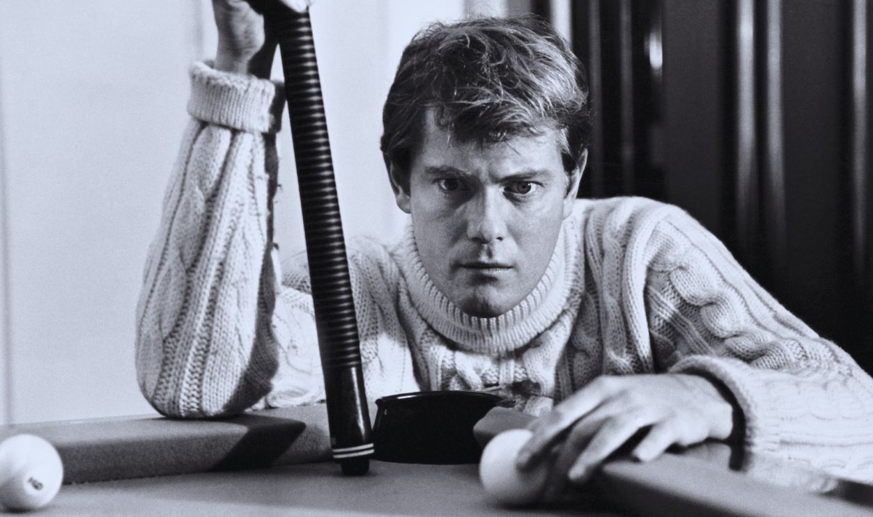 Gettyimages - 	2199406507, Troy Donahue At A Pool Table View of American actor Troy Donahue (1936 - 2001), a pool cue in one hand and a cue ball on the other, as he crouching down at the corner of a pool table, Beverly Hills, California, 1966. 