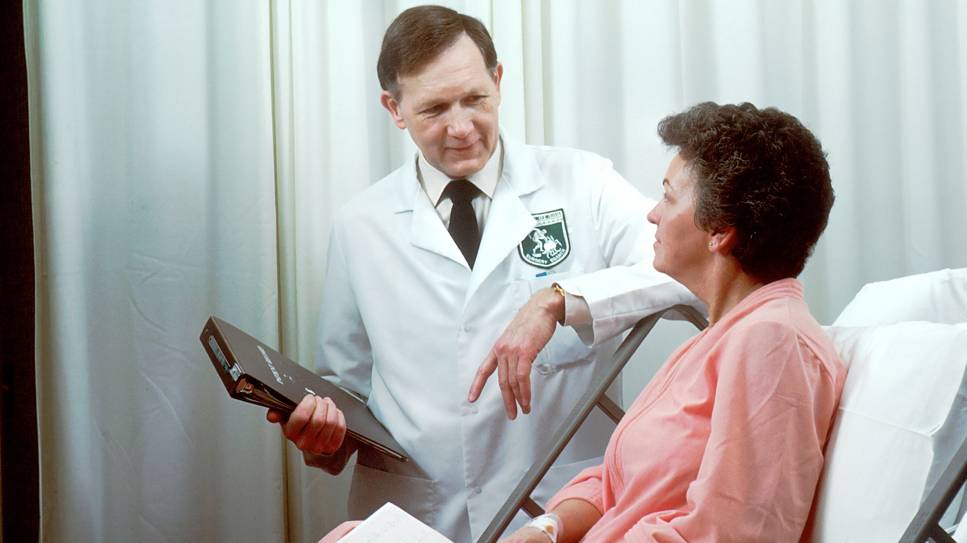 man in white button up shirt holding black tablet computer