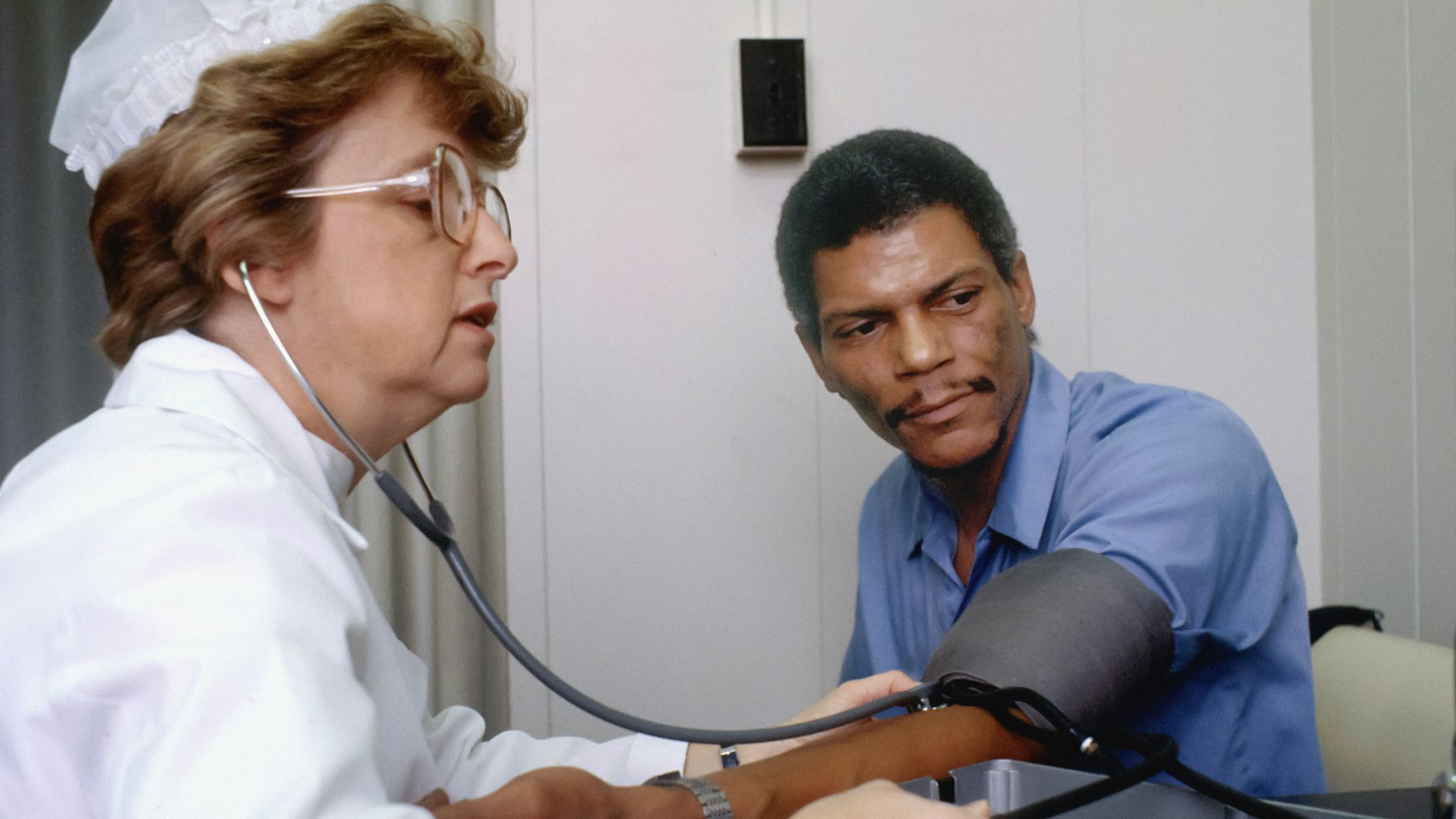 a doctor listening to a patient with a stethoscope