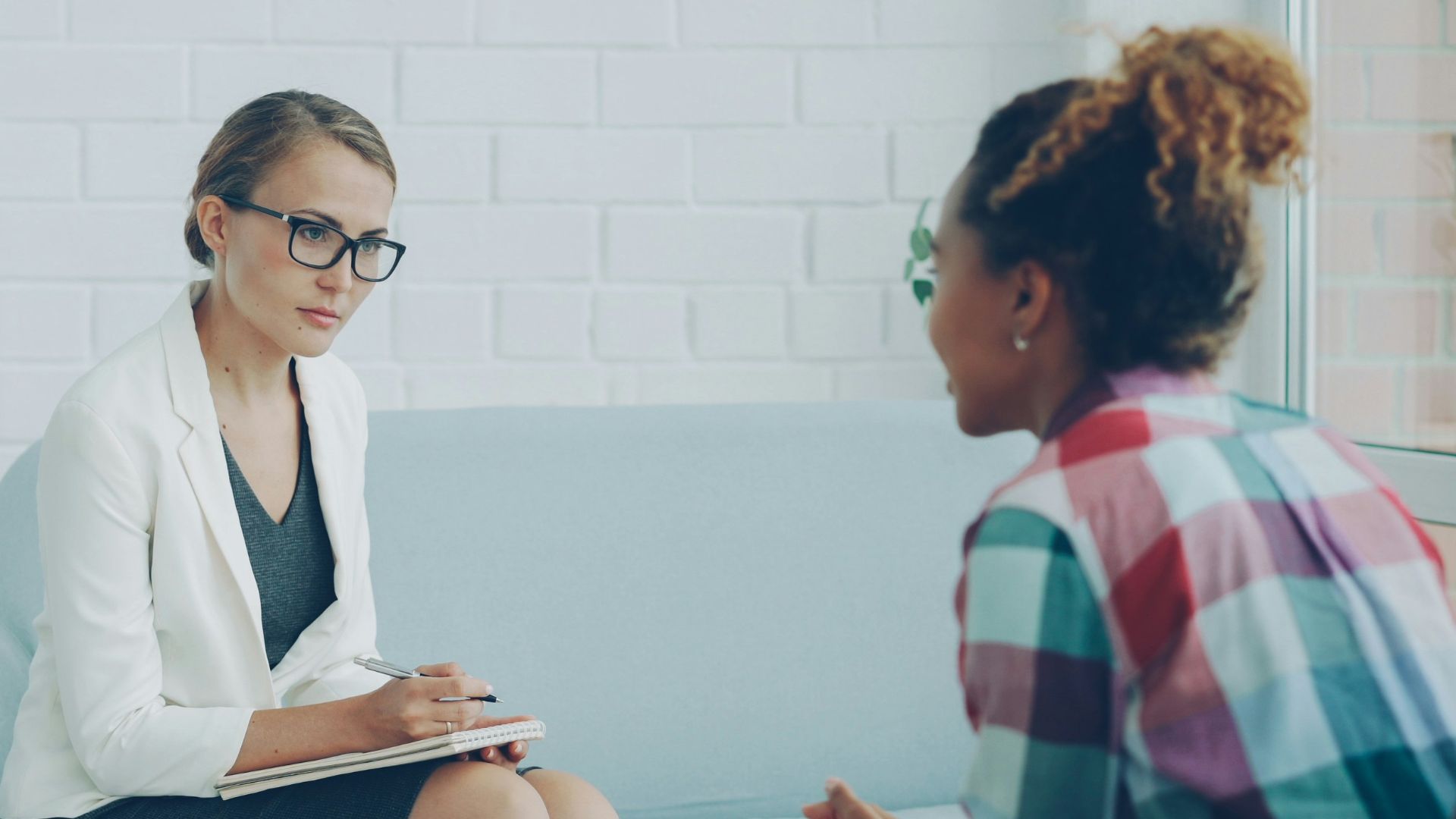 Two women talking in a therapy session