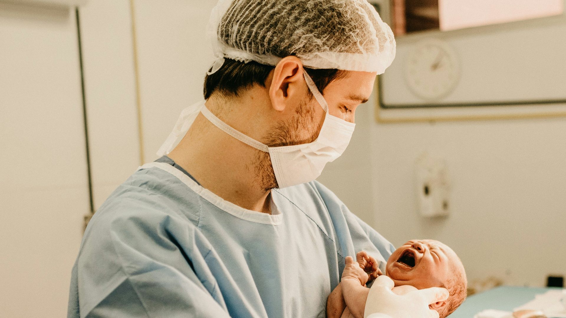 shallow focus photo of person carrying baby