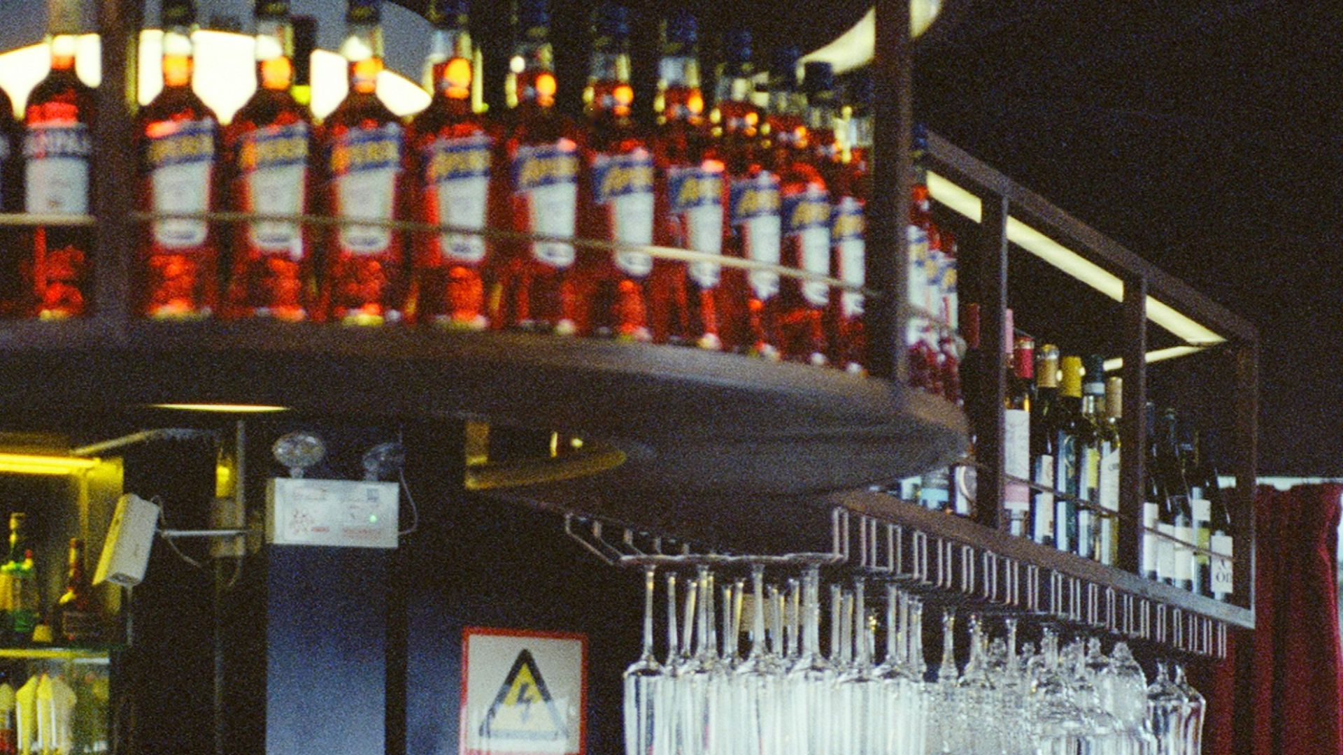 Bartender working behind a bar with bottles