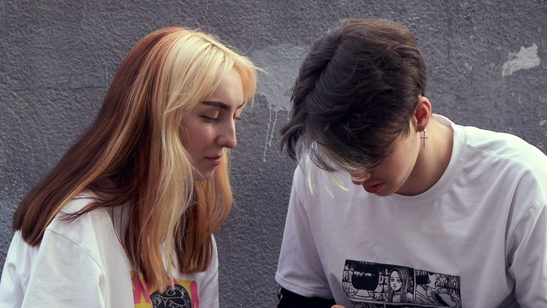 man in white crew neck t-shirt sitting beside woman in white crew neck t-shirt