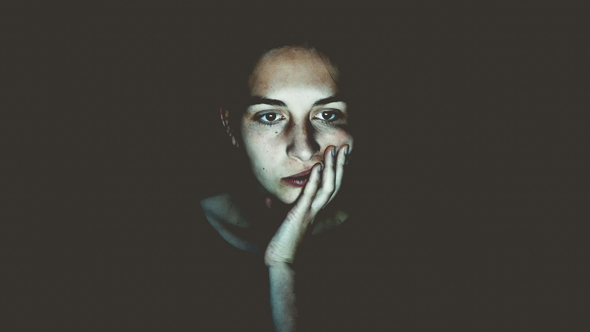woman with head resting on hand