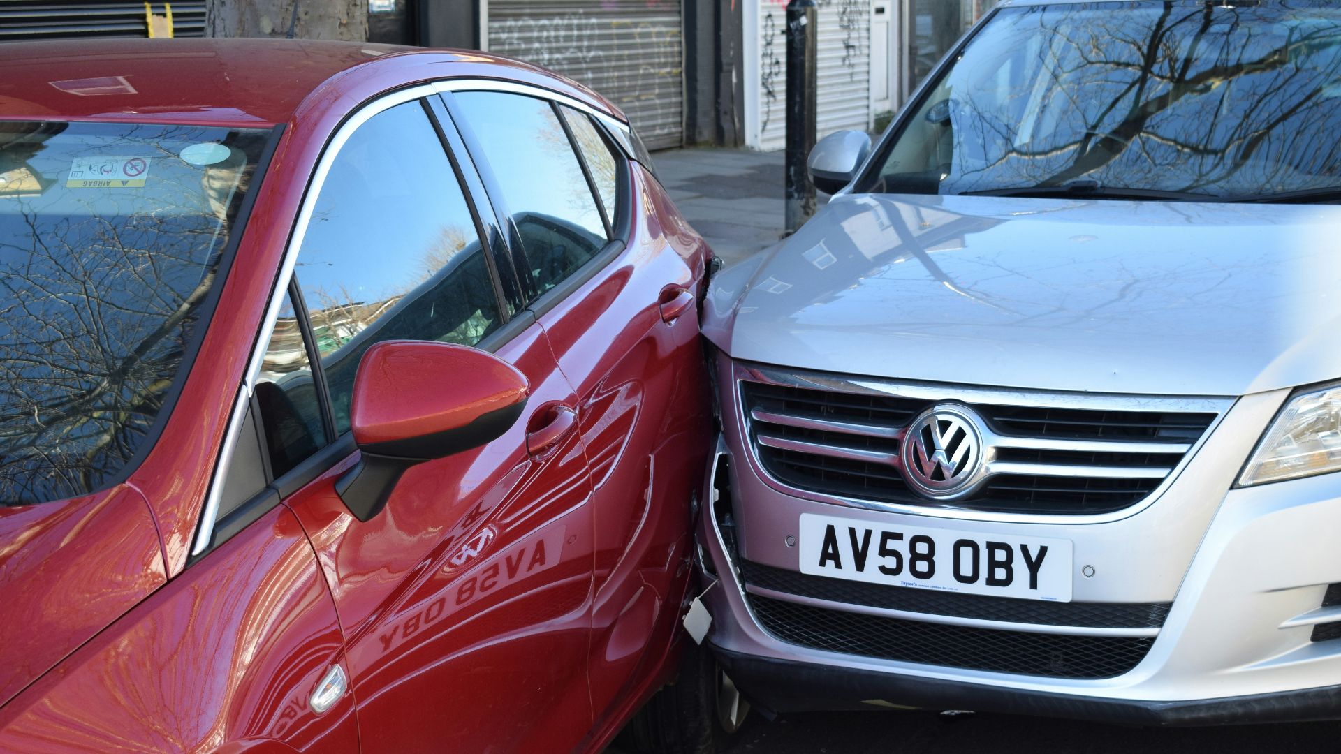 two cars parked next to each other in a parking lot