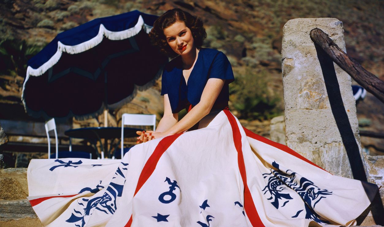  Gettyimages - 2078626401, Jean Peters Jean Peters posing by blue sun umbrella, circa 1946.