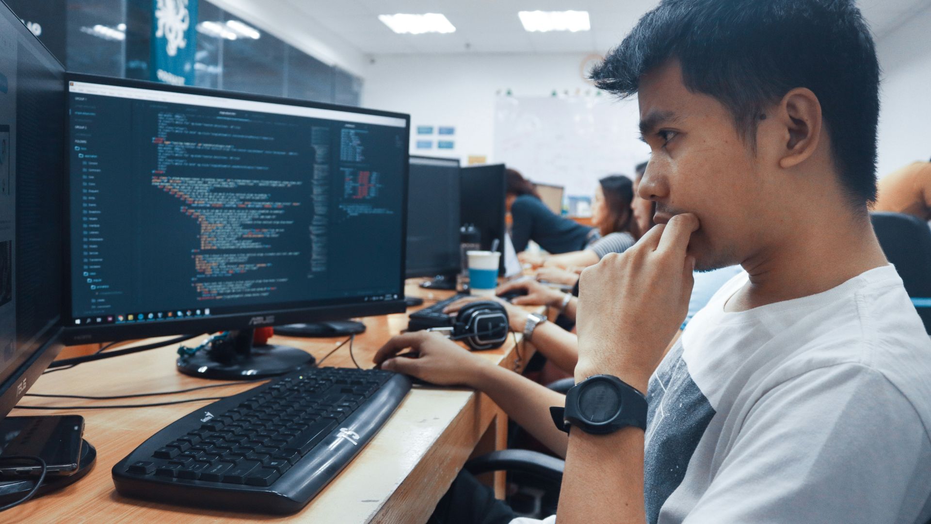 person holding a computer mouse in a room