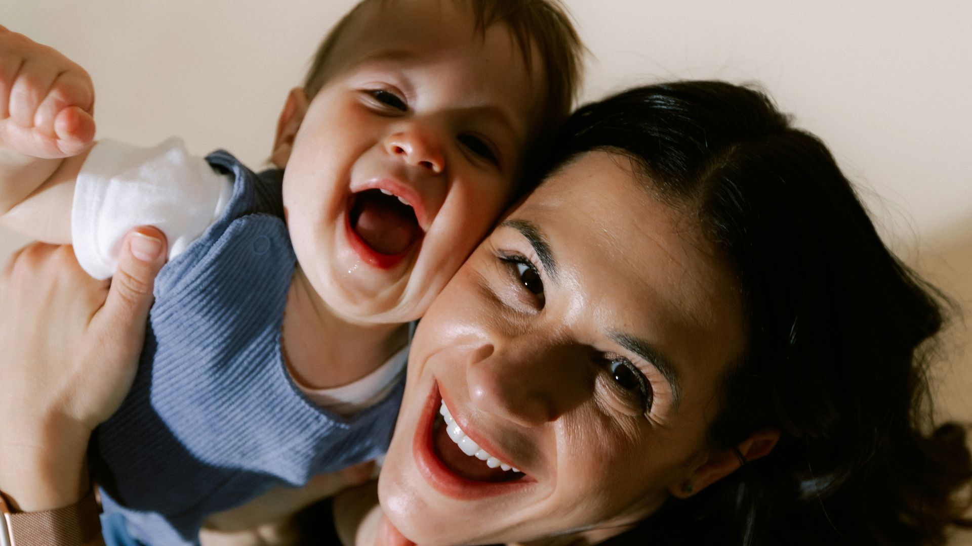 Mother and baby laughing together joyfully