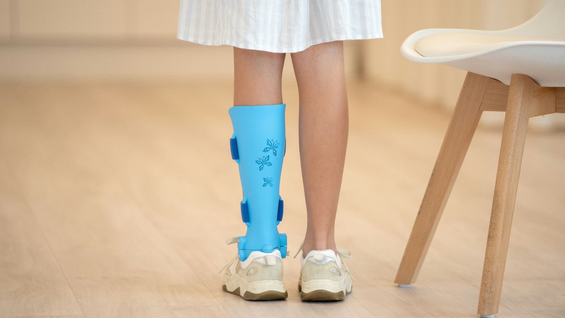 a person with a broken leg wearing a pair of blue boots