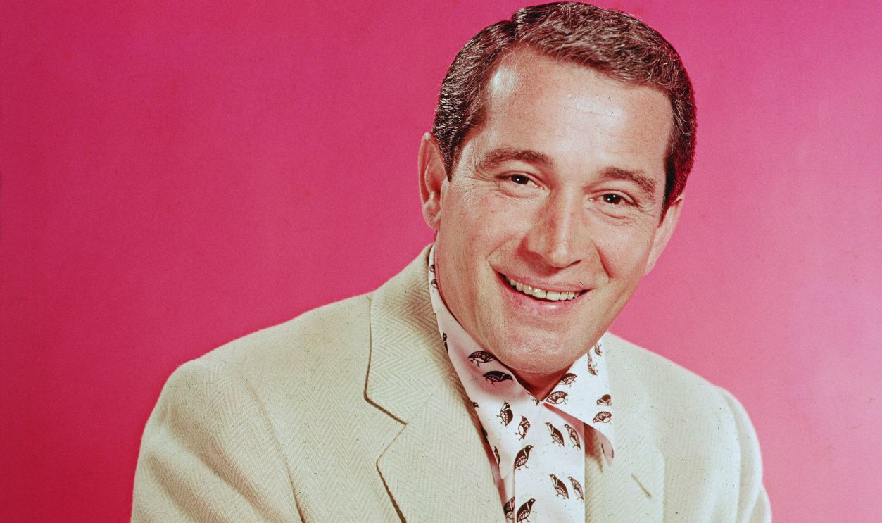 Gettyimages - 53203755, Portrait Of Perry Como Portrait of popular American singer Perry Como (1912 - 2001) as he sits in a pink and black shirt under a light tan jacket, mid 1950s. 