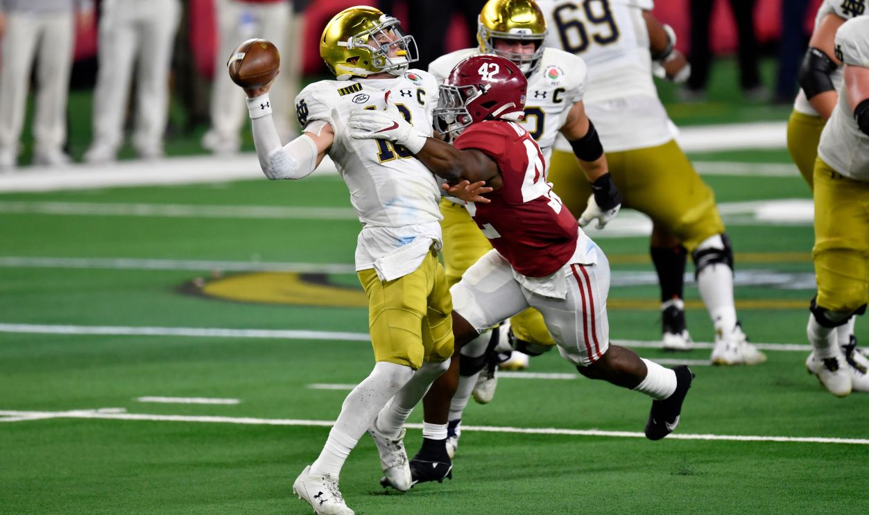 Gettyimages - 1295421289, College Football Playoff Semifinal at the Rose Bowl Game presented by Capital One - Alabama v Notre Dame ARLINGTON, TEXAS - JANUARY 01: Ian Book #12 of the Notre Dame Fighting Irish is pressured by Jaylen Moody #42 of the Alabama Crimson Tide during the College Football Playoff Semifinal at the Rose Bowl football game at AT&T Stadium on January 01, 2021 in Arlington, Texas. The Alabama Crimson Tide defeated the Notre Dame Fighting Irish 31-14. 