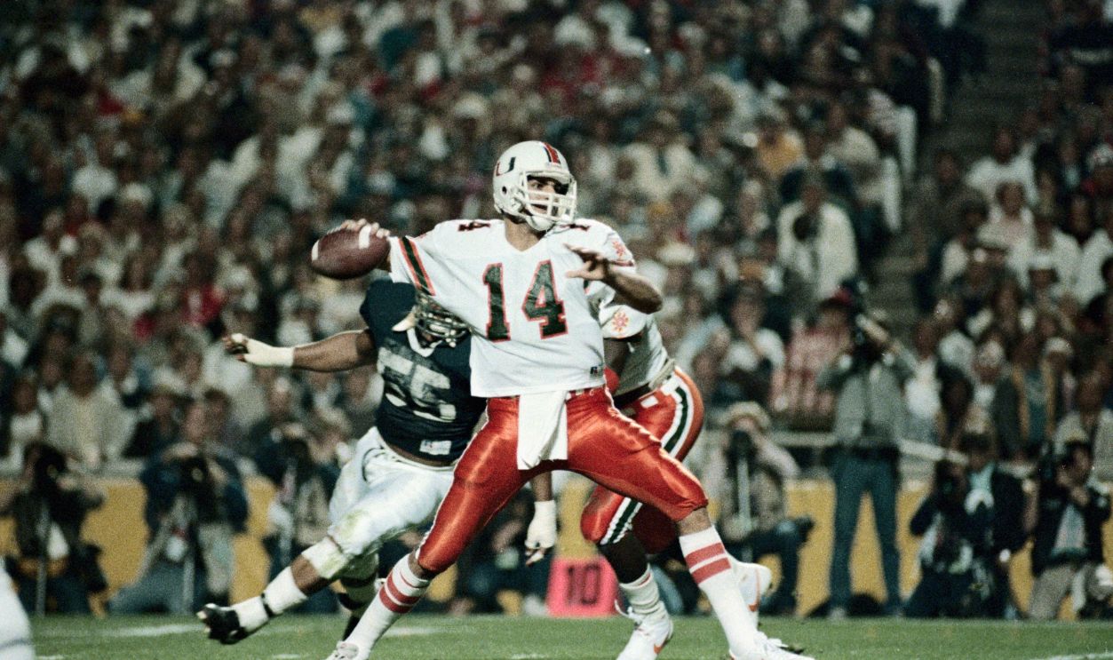 Gettyimages - 515208232, Football Action at the Fiesta Bowl (Original Caption) Tempe, Arizona: Under pressure from Penn State tackle Tim Johnson (#55, background) Miami quarterback Vinny Testaverde (#14) aims down field during first quarter action at the Fiesta Bowl 1/2 in Tempe.