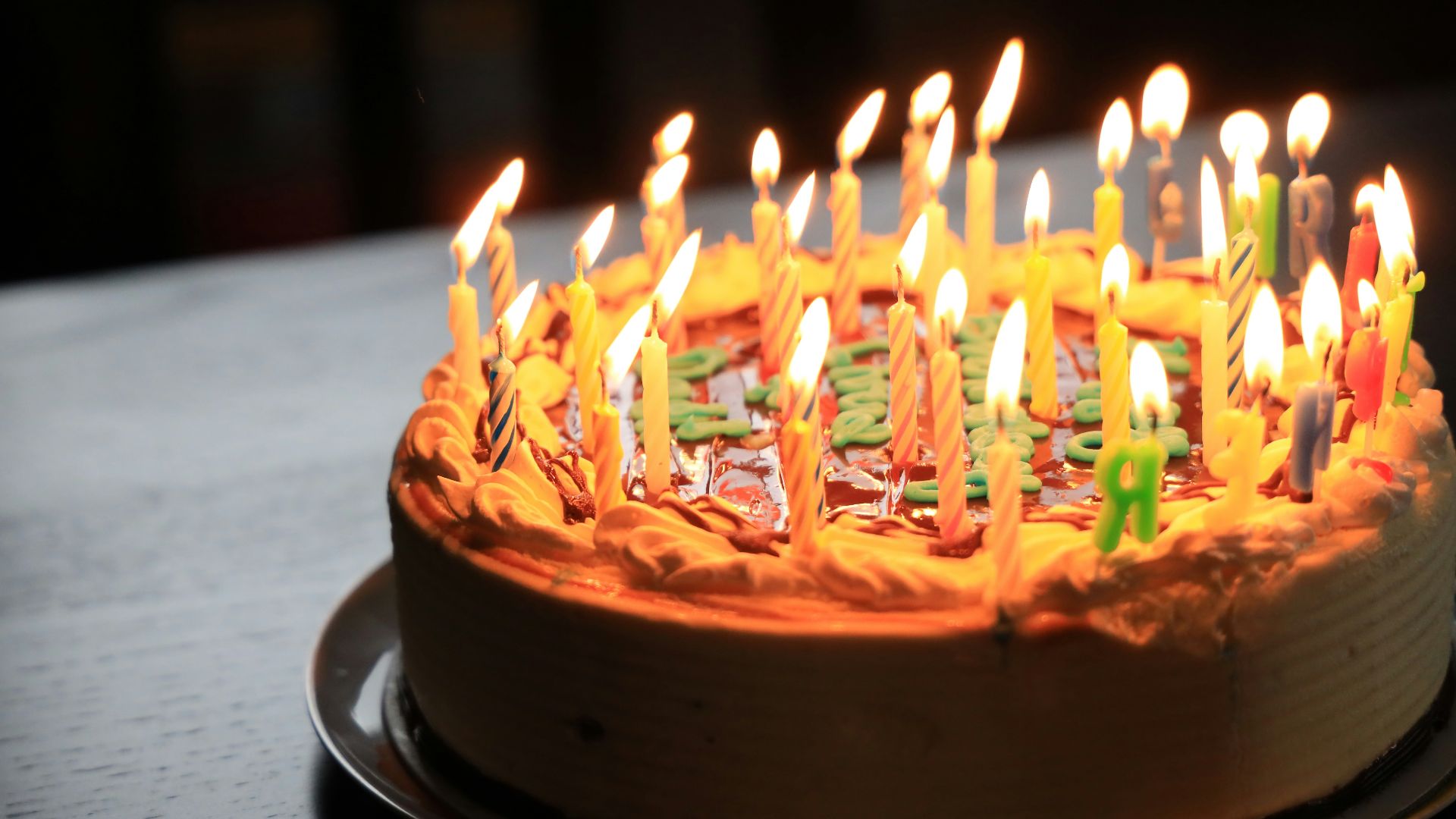 lighted candles on brown cake