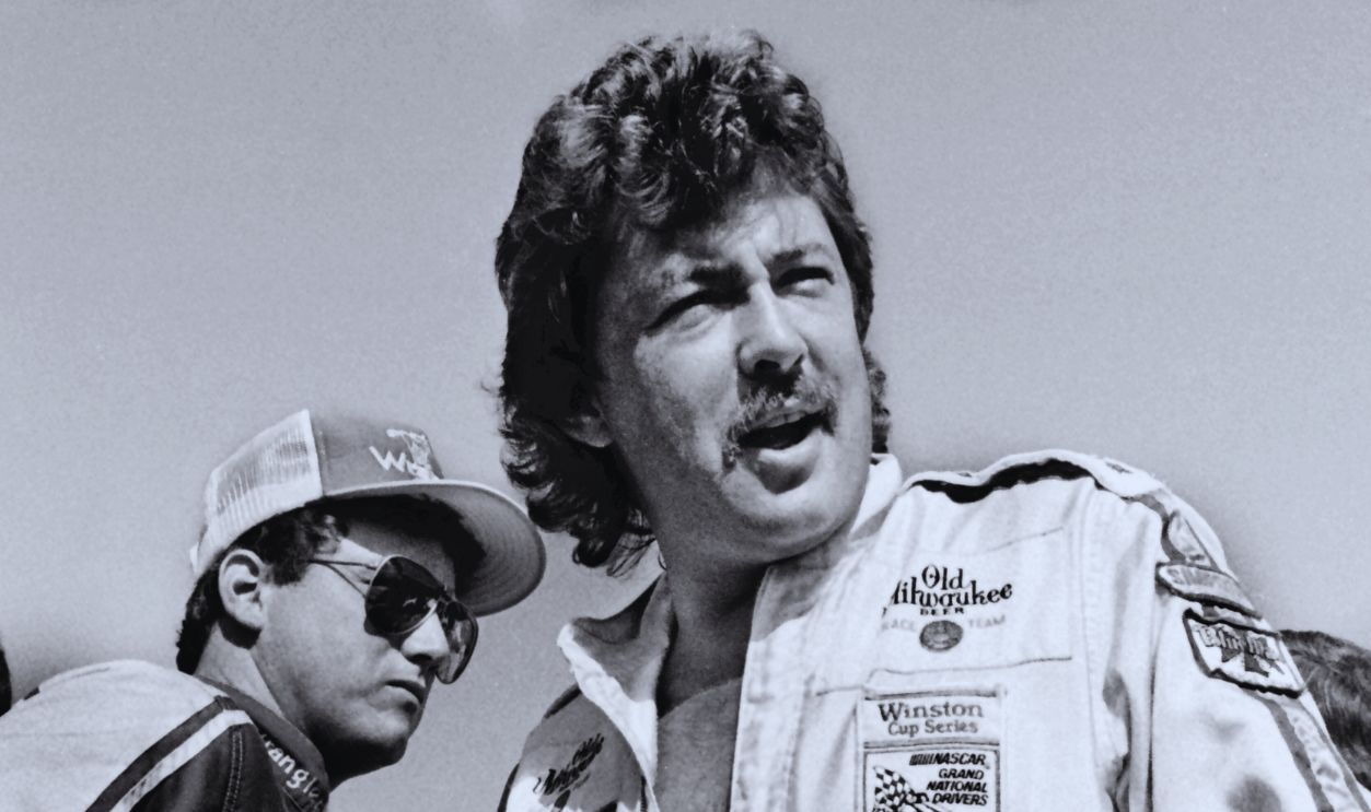 Gettyimages - 1347525797, NASCAR driver Tim Richmond DAYTONA BEACH, FLORIDA - JULY 1984: NASCAR drivers Tim Richmond, right, and Ricky Rudd stand on the podium during drivers' introductions prior to the start of the 1984 Firecracker 400 stock car race at Daytona International Speedway in Daytona Beach, Florida. 