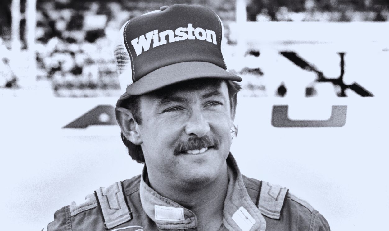Gettyimages - 1203770190, NASCAR driver Tim Richmond... DAYTONA BEACH, FLORIDA - FEBRUARY 1986: NASCAR driver Tim Richmond poses for photographers prior to the start of the 1986 Daytona 500 stock car race at Daytona International Speedway in Daytona Beach, Florida. 