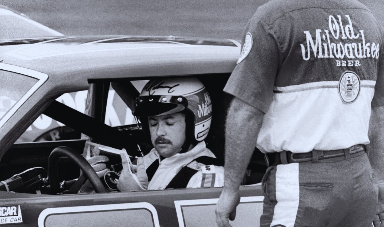 Gettyimages - 136253385, 1983 Firecracker 400 DAYTONA BEACH, FL - JULY 3, 1983: NASCAR driver Tim Richmond talks with a crew member after qualifying for the 1983 Firecracker 400 on July 3, 1983 at the Daytona International Speedway in Daytona Beach, Florida. 