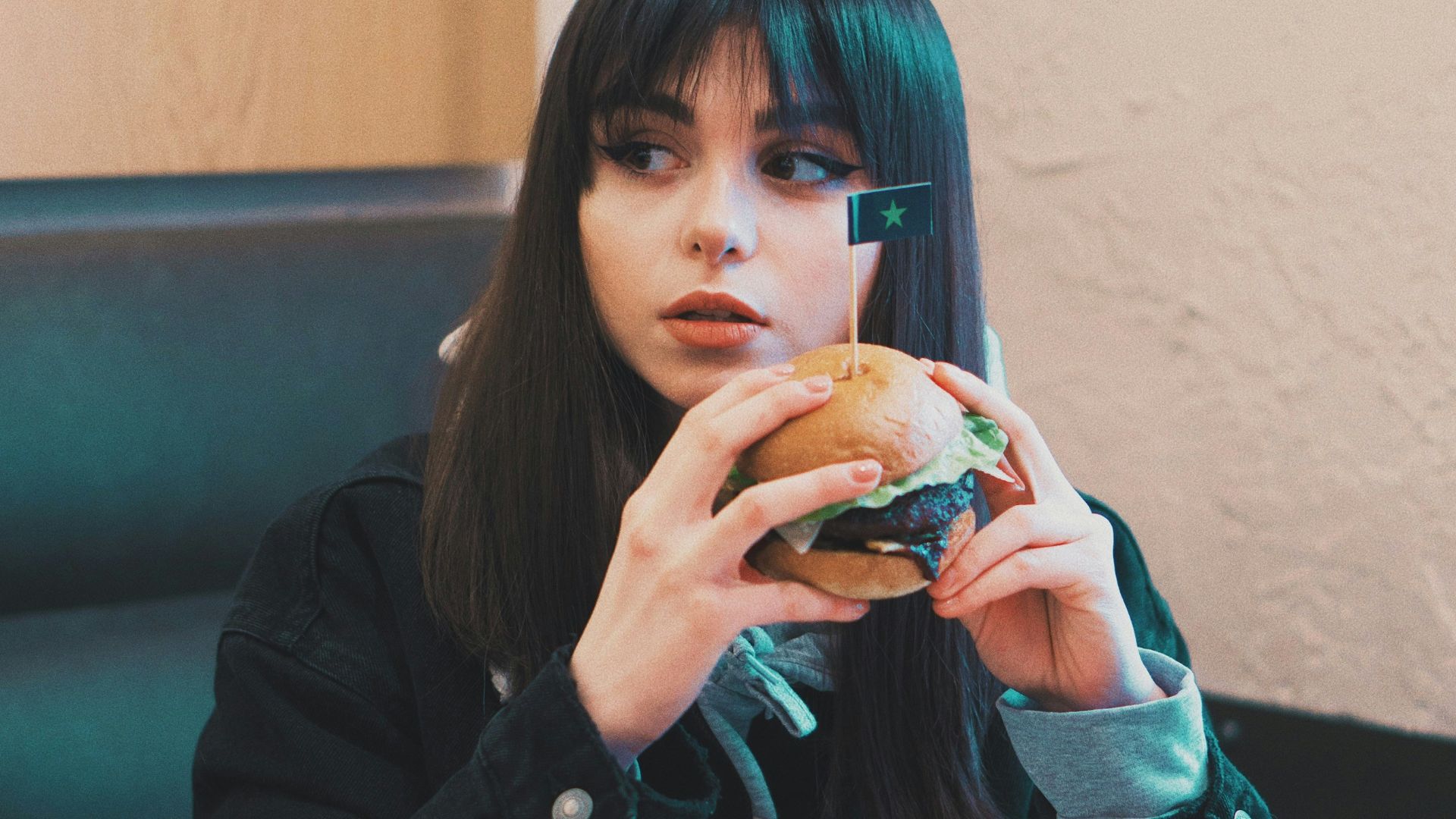 woman holding burger