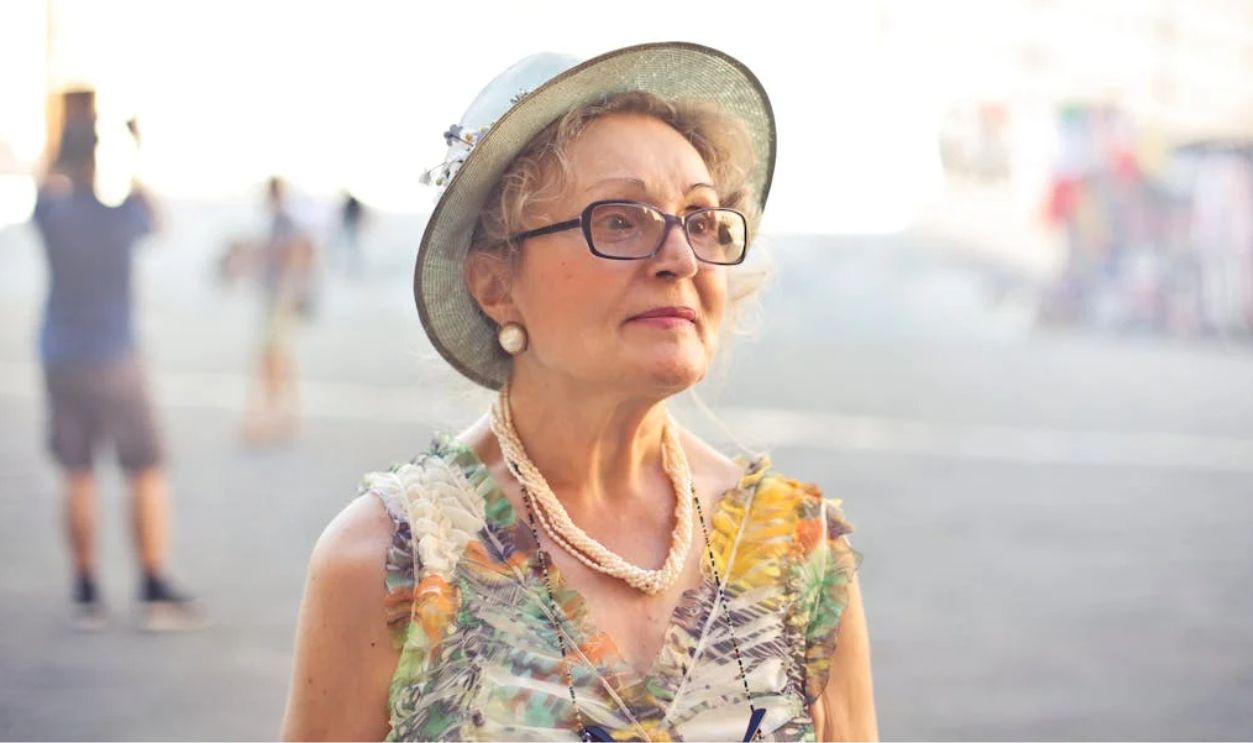 Woman in Pastel Color Sleeveless Shirt and White Sunhat