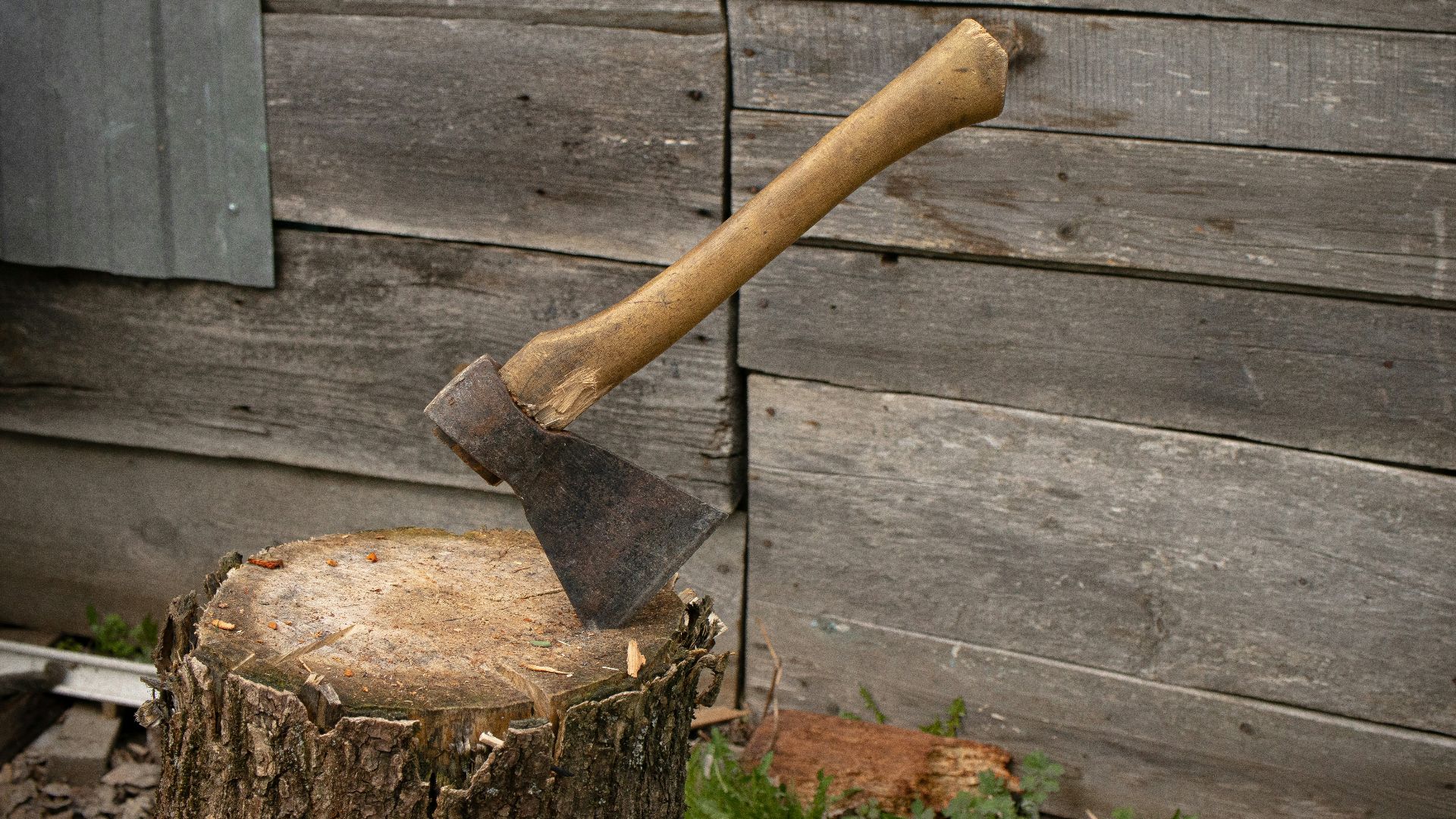 a hammer and a nail on a wooden surface