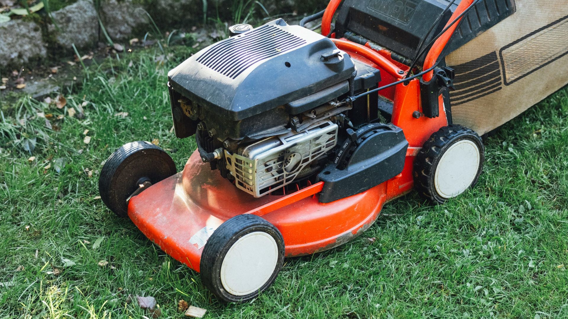 A lawn mower sitting on top of a lush green field
