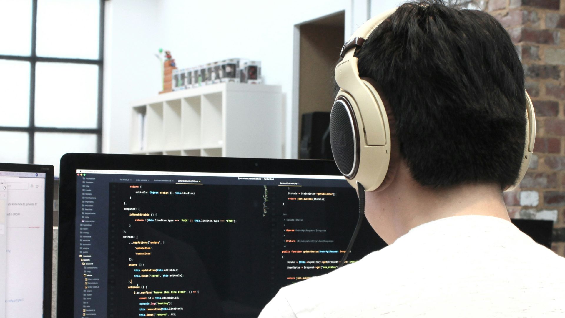 man wearing headphones while using computer